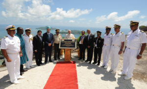 File image of Modi unveiling a plaque to mark the opening of the Coastal Surveillance Radar station at Mahe. Other dignitaries, including five naval officers in uniform stand on his either side. Sea and islands in the background